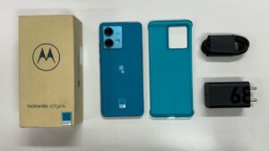 Moto Edge 40 Neo in blue color with box and box acessories infront of white table