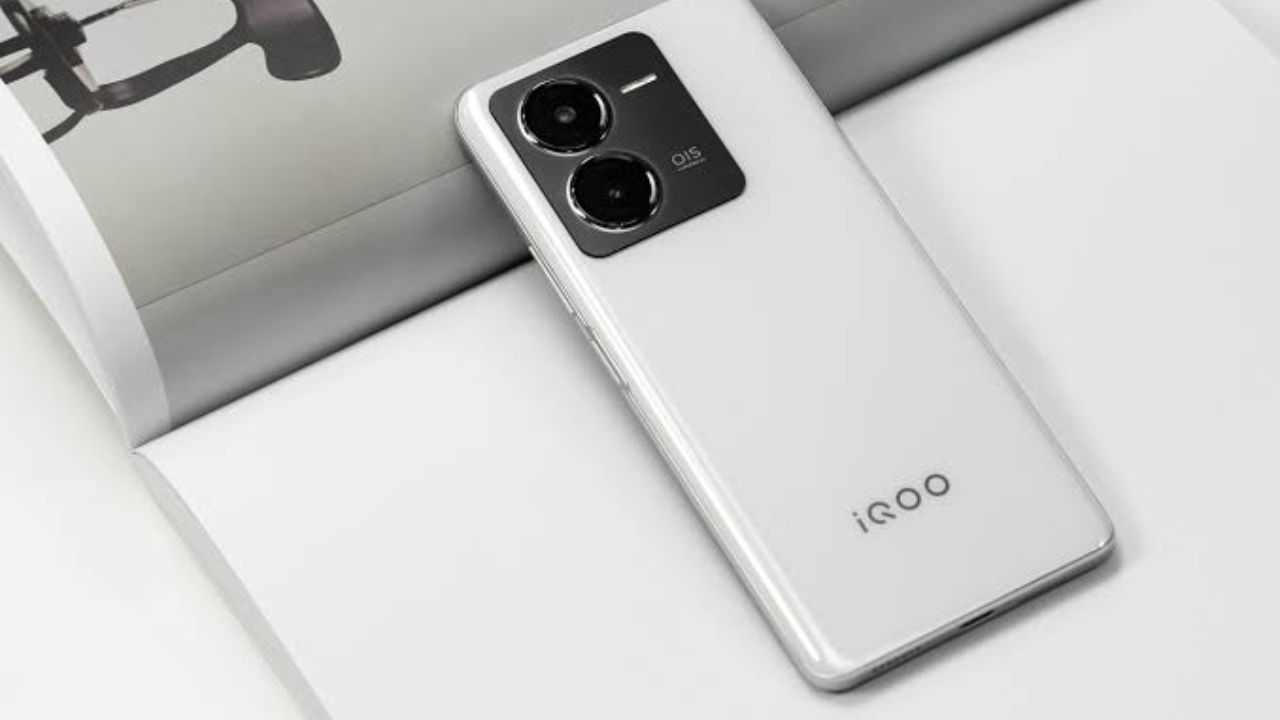 Here is of White colour iQOO Z9 5G smartphone placed a book